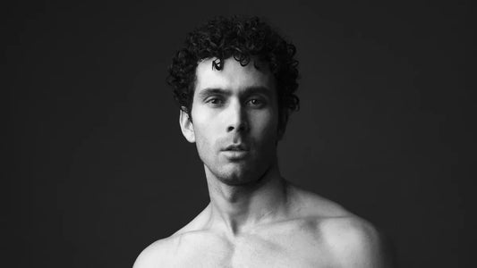 Shirtless man with curly hair, black and white portrait