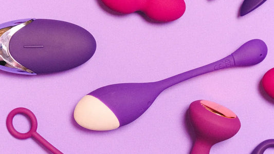 Purple and pink vibrators with silicone texture on lavender background, adult toys collection