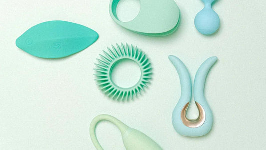 Assorted adult toys in soft teal and mint, including rings and vibrators for intimate pleasure.