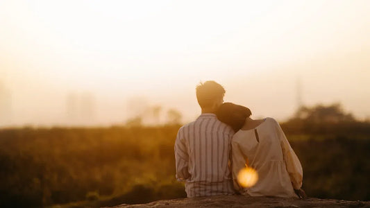 Couple embracing at sunset, enjoying romantic intimacy outdoors